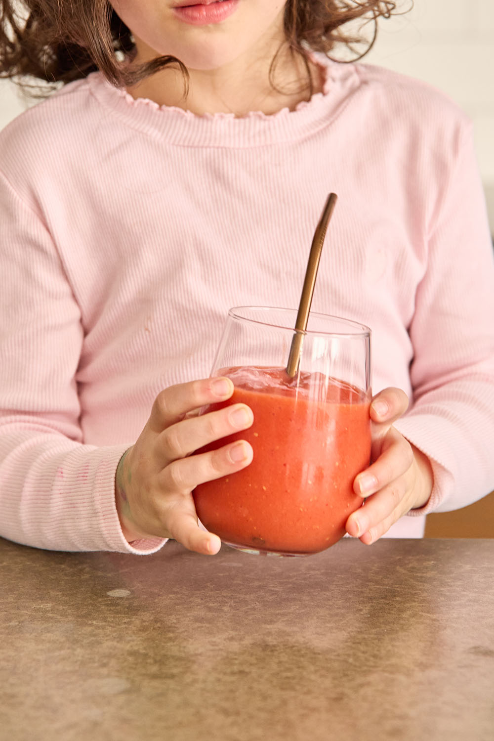 Young girl drinking homemade smoothie