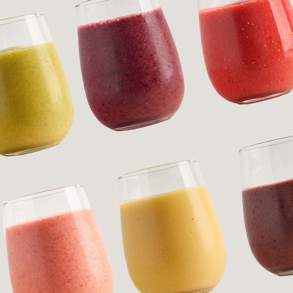 Healthy smoothies in glasses made with ready-to-blend packs lined up